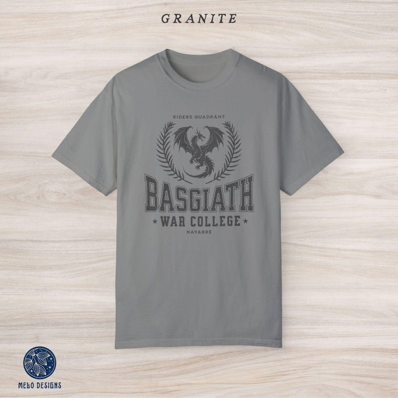 Puede incluir: Una camiseta gris con un gr&aacute;fico de drag&oacute;n negro y el texto "Riders Quadrant Basgiath War College Navarre".