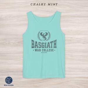 May include: A light blue tank top with a grey graphic of a dragon and the text "Basgiath War College, Navarre".