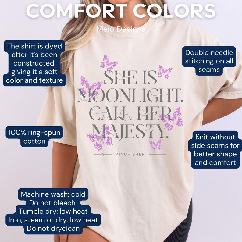 May include: A cream-coloured t-shirt with the text "She is Moonlight. Call Her Majesty." in grey with purple butterfly graphics. The shirt is made of 100% ring-spun cotton and has a comfortable fit.