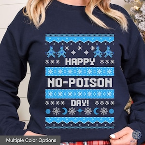 May include: A navy blue sweatshirt with a blue and white Christmas sweater design. The sweater features a snowman design with the text "Happy No-Poison Day!"