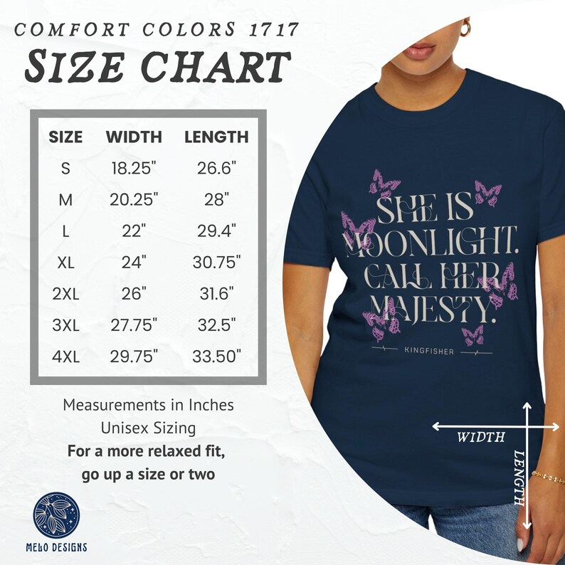 May include: A navy blue t-shirt with a size chart in inches. The shirt features a pink butterfly design and the text "She is Moonlight. Call Her Majesty." with the word "Kingfisher" below the text.