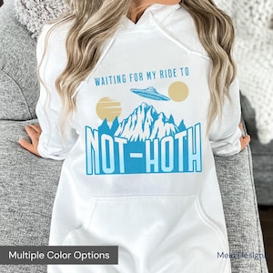 May include: White hoodie with a blue and white graphic that says "Waiting for my ride to Not-Hoth". The graphic features a mountain range and a UFO.