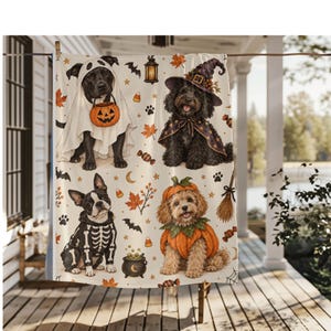 May include: A cream-colored throw blanket featuring a repeating pattern of dogs in Halloween costumes, including a ghost, a witch, a skeleton, and a pumpkin. The design also includes orange maple leaves, candy corn, bats, and a cauldron.