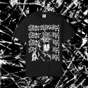 May include: Black t-shirt with a white graphic of a snarling dog and the text "SKIT SYSTEM" repeated vertically. The design is bold and graphic, suitable for casual wear.