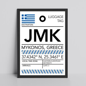 May include: A framed print featuring a luggage tag design for Mykonos, Greece. The design includes the Greek flag, the letters JMK, and the destination coordinates. The print also displays the local time zone and arrival gate.