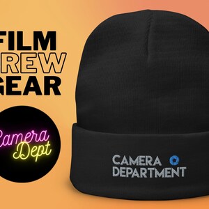 May include: Black beanie with a white embroidered logo that says "CAMERA DEPARTMENT" and a small blue circle with a camera icon.