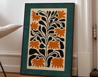 May include: A rectangular framed wall art print featuring a stylized botanical illustration. The design displays dark black leaves and stems with vibrant orange flower blossoms set against a light cream background, enclosed by a dark green border.