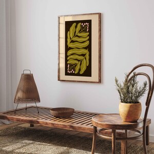 Pu&ograve; includere: Una stampa botanica incorniciata con un design simmetrico di foglie verde oliva e grappoli di bacche rosa su sfondo scuro. L'opera &egrave; racchiusa in una cornice di legno, aggiungendo calore naturale all'arredamento.