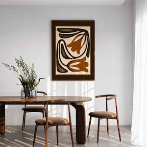 May include: A white ceramic mug with a black handle and the text "But First, Coffee" in a bold, black font. The mug is set against a blurred background, highlighting its clean design.