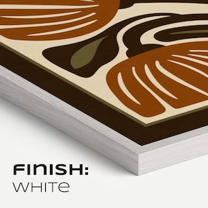 May include: A framed art print with a white finish. The artwork features an abstract design in shades of brown, beige, and olive green. The text "FINISH: WHITE" is printed in black at the bottom of the frame.