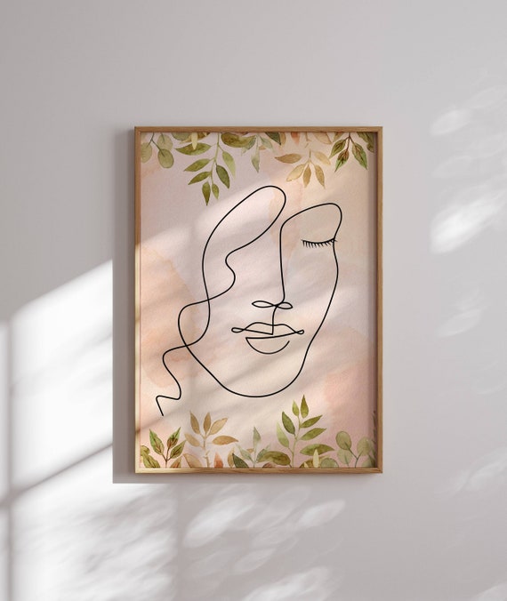 Minimalist wall art featuring a serene line art face with watercolor leaves on soft pastels — ideal for boho decor and modern spaces.