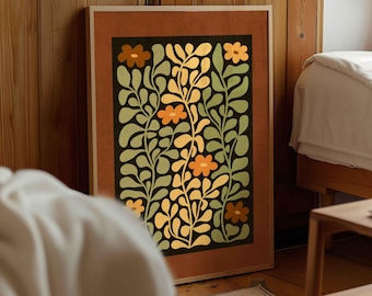 以下が含まれることがあります： 額縁に入った、様式化された花の絵画。このアートワークは、緑と黄色の葉とオレンジ色の花が描かれた黒い背景が特徴です。フレームは温かみのある茶色で、作品にエレガンスを加えています。