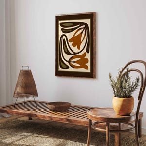 May include: A white ceramic mug with a black handle and the text "But First, Coffee" in a bold, black font. The mug is set against a blurred background, highlighting its simple design.