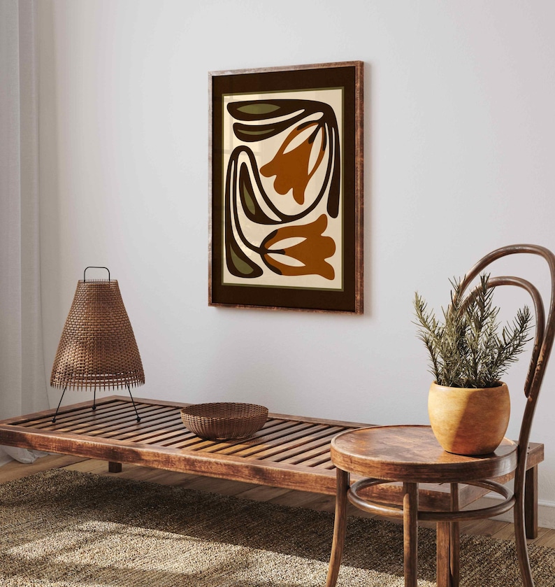 May include: A white ceramic mug with a black handle and the text "But First, Coffee" in a bold, black font. The mug is set against a blurred background, highlighting its simple design.