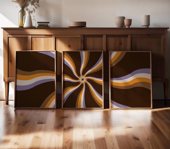 Sunburst wall art in a groovy 70s triptych—psychedelic swirls and retro tones meet mid-century charm for a bold, vintage statement.