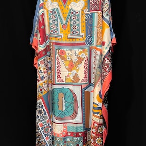 May include: A long, flowing, blue, red, orange, and yellow patterned kaftan with a large, colorful, graphic print of the letters "MYD".