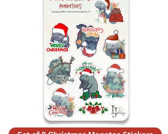 May include: A sticker sheet titled Funny Christmas ManaTees featuring eight individual illustrations of gray manatees wearing red Santa hats, some with reindeer antlers, Christmas presents, stockings, and holly, with Merry Christmas text.