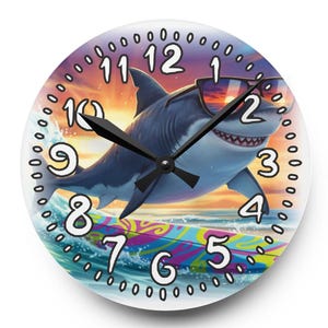 May include: Round wall clock featuring a cartoon shark wearing sunglasses, riding a surfboard. The clock face has black hands, a white background, and a colorful ocean scene. Numbers 1-12 are displayed.