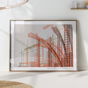 May include: A framed print of a black and white architectural drawing with orange and green lines. The drawing is titled "Yakov Chernikhov - Arkhitekturnye fantazii 1933".
