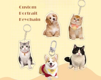 May include: Custom portrait keychains featuring a variety of pets, including a corgi, a cat, and a dog. The keychains are made of clear acrylic and have a silver metal ring.