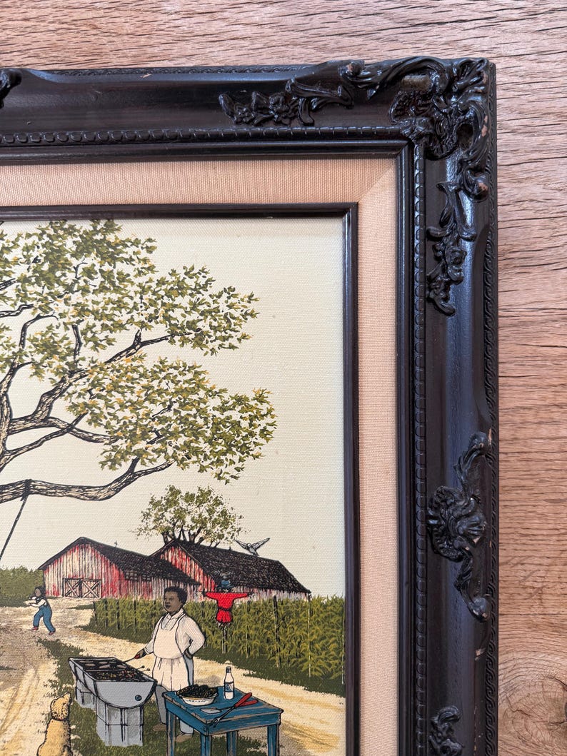 Peut inclure: Une peinture encadr&eacute;e repr&eacute;sentant une sc&egrave;ne rurale avec un homme faisant griller des aliments devant une grange rouge. La peinture est dans un cadre noir avec des d&eacute;tails orn&eacute;s.