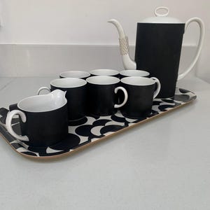 May include: A set of three ceramic mugs with a speckled, matte finish. The mugs are in shades of cream, light gray, and dark gray. Each mug has a simple, minimalist design, perfect for coffee or tea.