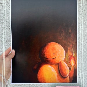 May include: A painting of a cartoon orange character with a flame tail. The character is smiling and has a dark background.