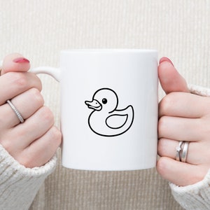 May include: White ceramic mug with a black outline of a rubber ducky.
