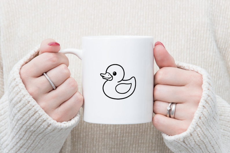 May include: White ceramic mug with a black outline of a rubber ducky.