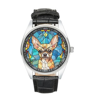May include: A silver wristwatch with a black leather strap. The watch face features a colourful stained glass design of a chihuahua.