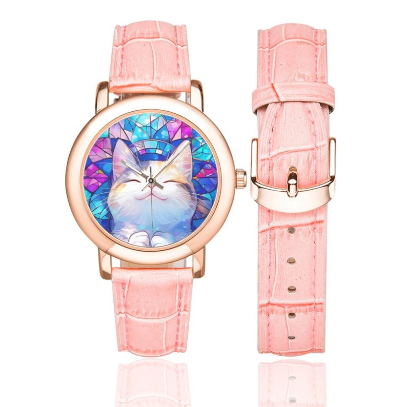 Op de afbeelding: Een roze leren polshorloge met een ros&eacute;gouden kast en een kleurrijk glas-in-loodontwerp met een lachende kat. Het horloge heeft een witte wijzerplaat met zwarte wijzers en zwarte cijfers.