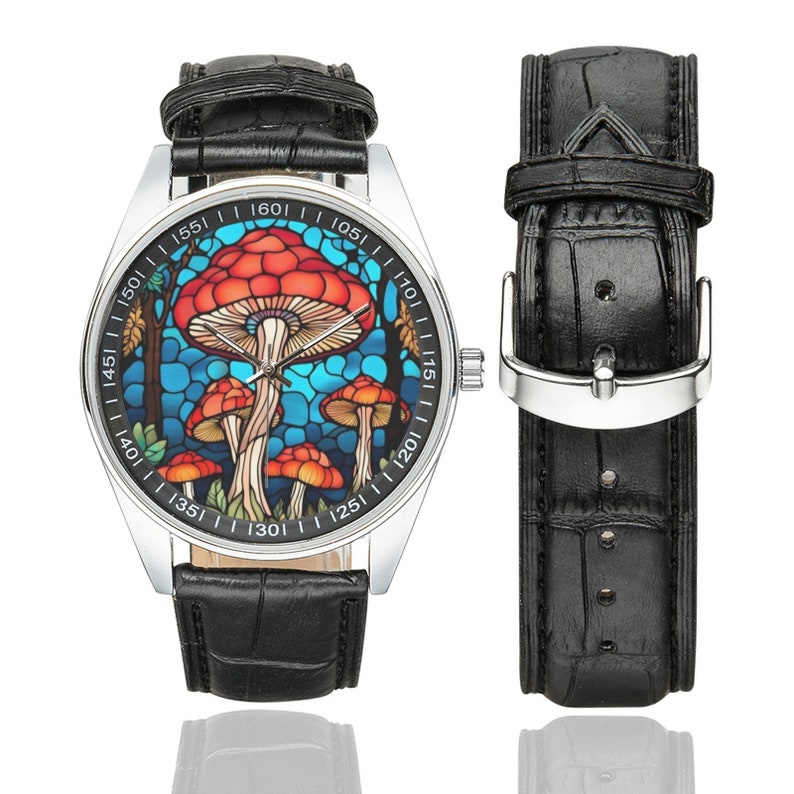 May include: A silver wristwatch with a black leather band. The watch face features a colorful stained glass design of mushrooms.