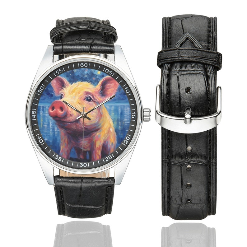 May include: A silver wristwatch with a black leather band features a colorful painting of a pig on the face. The watch face has white numbers and markings.