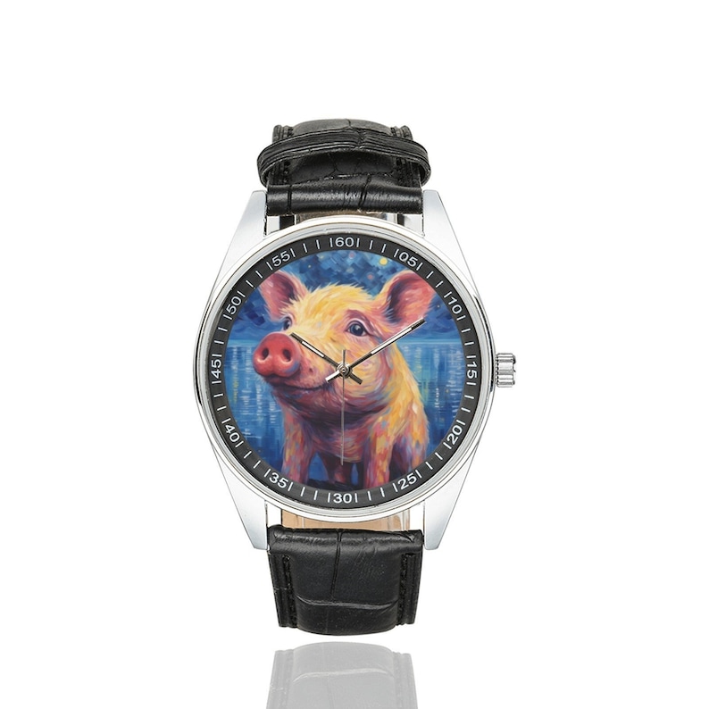 May include: A silver wristwatch with a black leather band. The watch face features a colorful painting of a pig with a blue background.