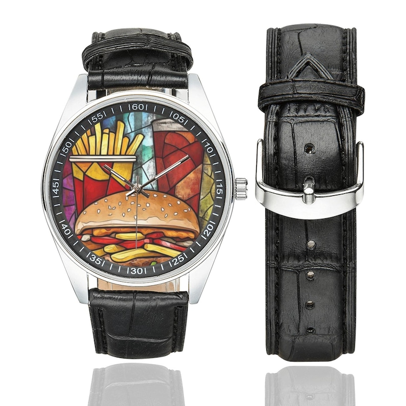 K&ouml;nnte beinhalten: Eine Edelstahl-Armbanduhr mit schwarzem Lederarmband. Das Zifferblatt zeigt eine farbenfrohe Grafik eines Hamburgers, Pommes Frites und eines Getr&auml;nks. Das Armband ist ca. 23 cm lang.