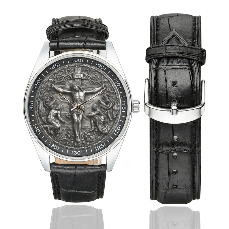 May include: A silver wristwatch with a black leather band. The watch face features a detailed, engraved image of Jesus Christ on the cross. The watch face has Roman numeral markings.