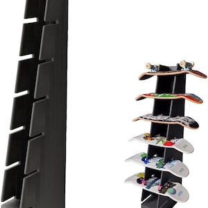 May include: A black skateboard rack with multiple shelves, designed to hold skateboards. The rack is shown empty and also with several skateboards displayed, showcasing its storage capacity and design. The skateboards have colorful graphics.