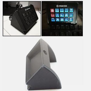 May include: A black plastic stand for a Stream Deck, a device with 15 customizable buttons. The stand has a raised back and a flat front, allowing the device to be tilted upwards.