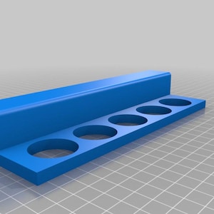 May include: A blue plastic organizer with six round holes for holding paint tubes or other small items.