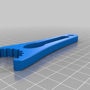 May include: A blue plastic tool with a serrated edge and a handle with a hole in it.