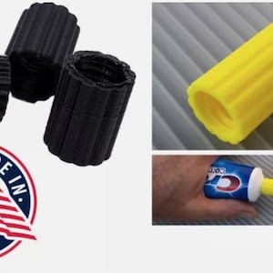May include: Three black and one yellow plastic tube-shaped adapters for squeezing toothpaste tubes. The adapters are ribbed and have a hole in the center. The image also shows a hand squeezing a tube of toothpaste with the adapter attached. The text "Crest" is visible on the toothpaste tube. Made in USA.