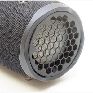 May include: A black portable Bluetooth speaker with a hexagonal speaker grill.