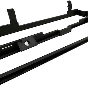 May include: Three black, geometric, 3D-printed components. The largest piece is a rectangular frame with raised sections and cutouts. A second piece is a narrower, stepped bar. The third is a long, thin, rectangular piece.