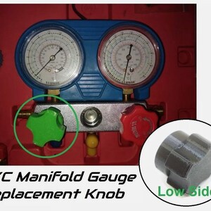 May include: A blue and silver A/C manifold gauge with two gauges and a green knob on the left side and a black knob on the right side. The text "Low Side" is printed in green below the black knob.