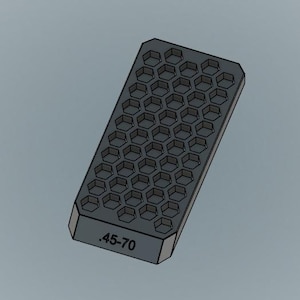 May include: A black plastic mold with a honeycomb pattern and the text ".45-70" printed on the bottom.