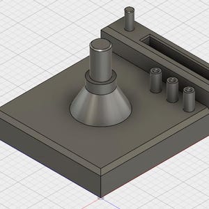 May include: A gray 3D printed organizer with a round base and a slot for holding small items. The organizer has four slots for holding small items, such as pens or pencils.