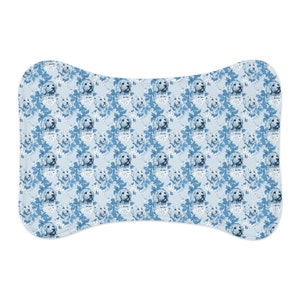 May include: A blue and white patterned dog bone shaped pet bed with a repeating pattern of dog faces.