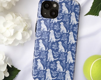 May include: A blue phone case featuring a repeating pattern of white dogs and floral elements. The case has a glossy finish and a camera cutout. A tennis ball and white flowers are in the background.
