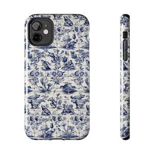May include: A white and blue phone case with a pattern of frogs and flowers. The case is designed to fit an iPhone.