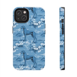 May include: A blue phone case with a repeating pattern of white flowers and blue dogs. The case is designed for an iPhone.